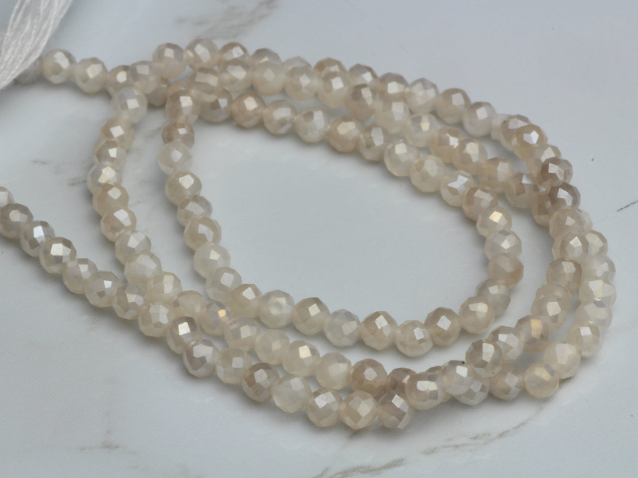 Coated White Moonstone 2.5mm Faceted Rounds