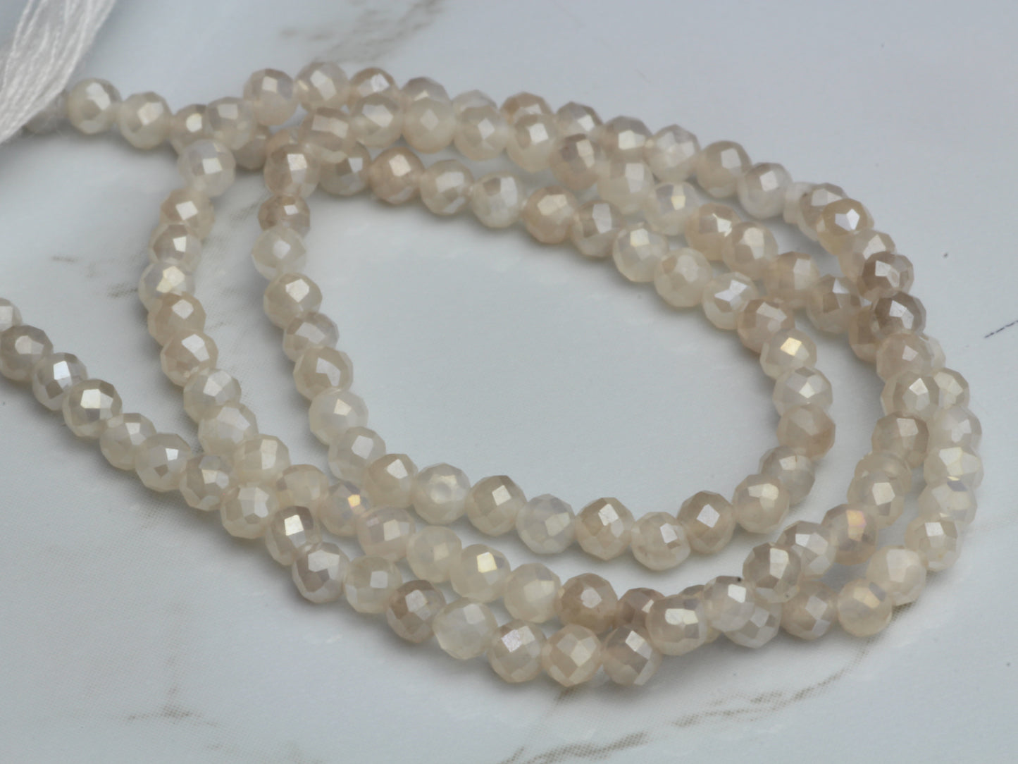 Coated White Moonstone 2.5mm Faceted Rounds
