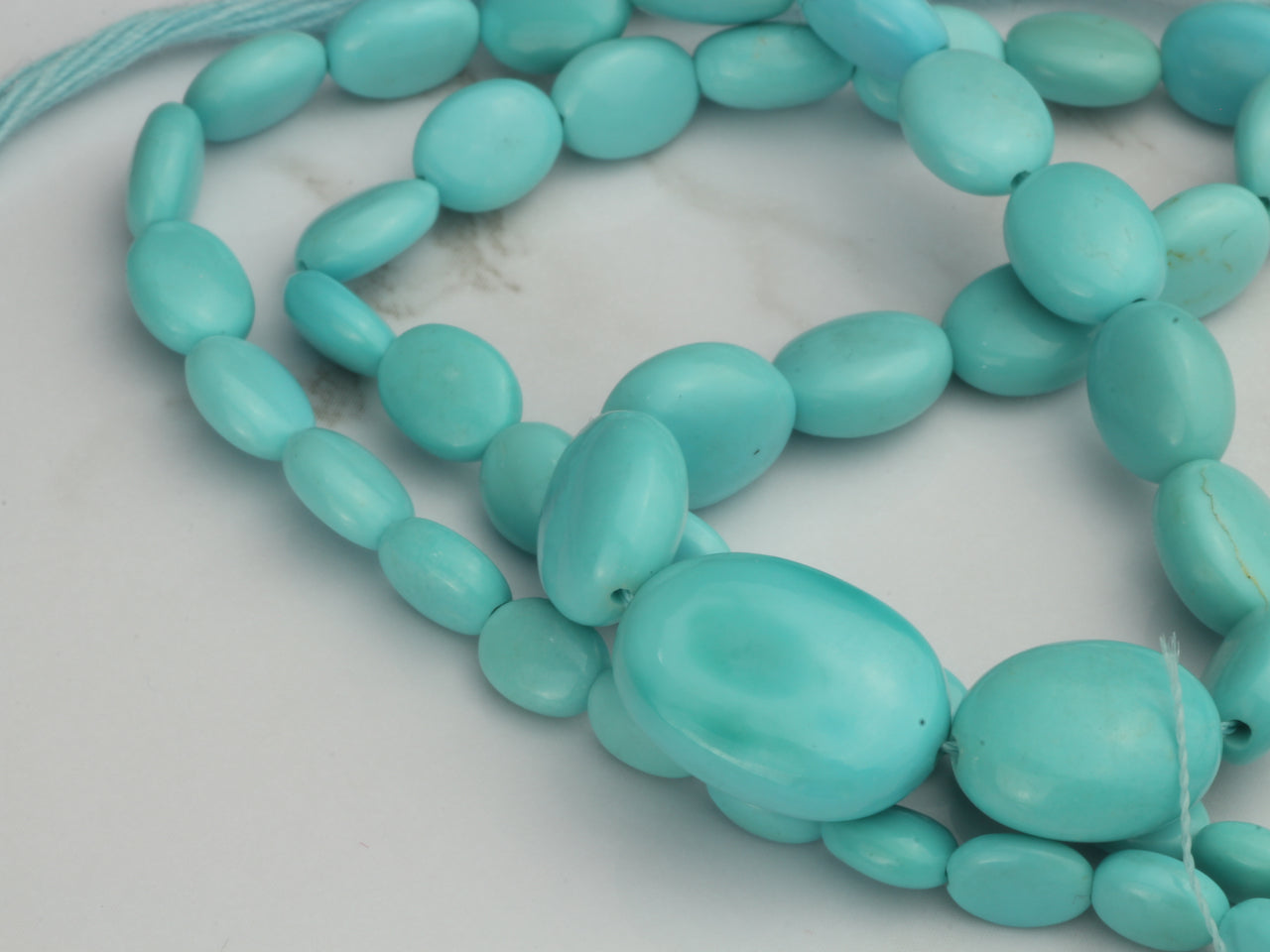 Sleeping Beauty Turquoise 7x5mm - 12x10mm Smooth Ovals Bead Strand