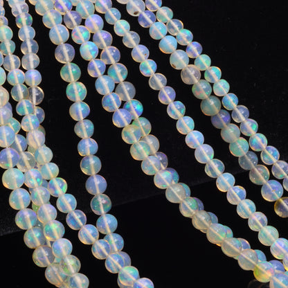 Warm White Ethiopian Opal 4mm - 5.5mm Smooth Rounds Bead Strand