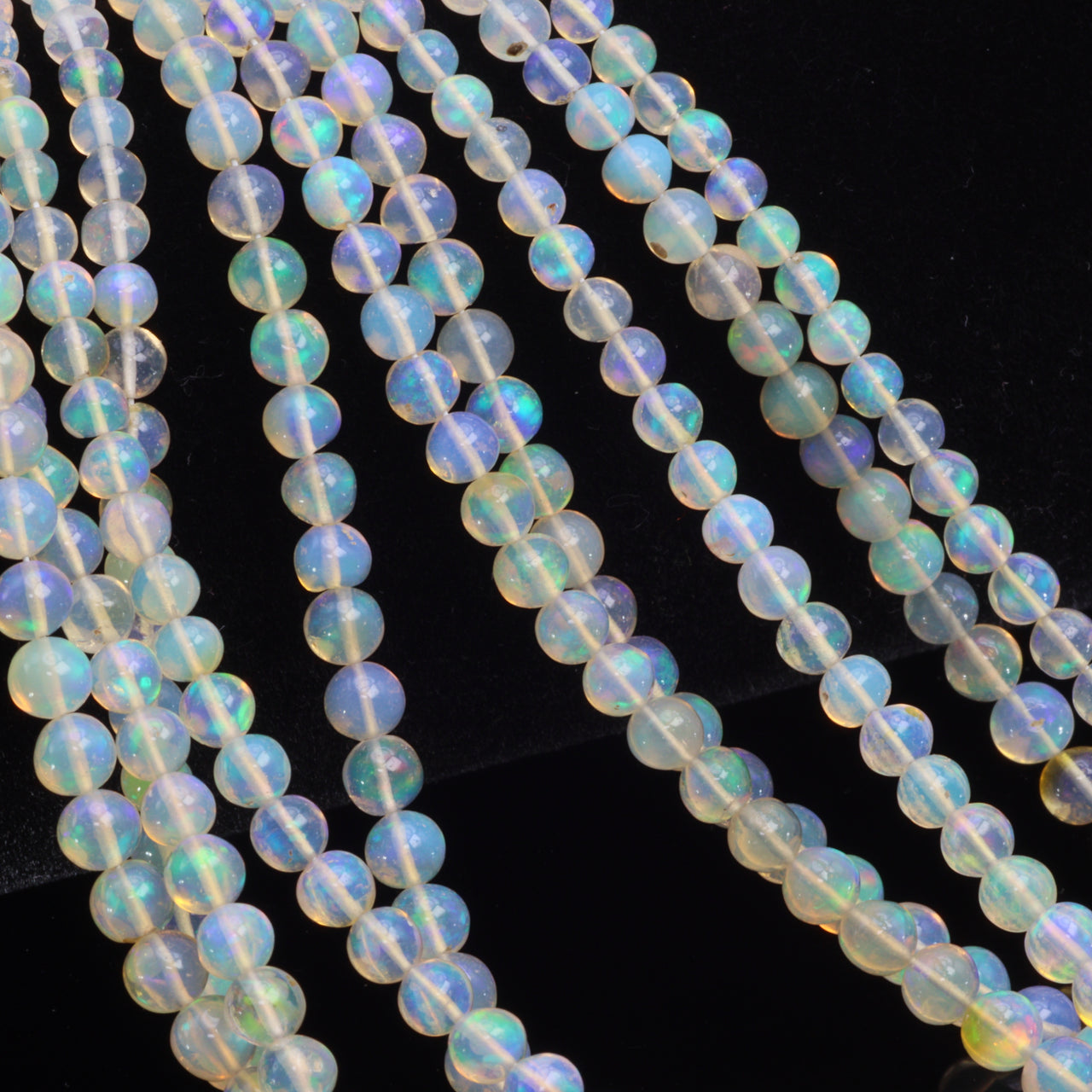 Warm White Ethiopian Opal 4mm - 5.5mm Smooth Rounds Bead Strand
