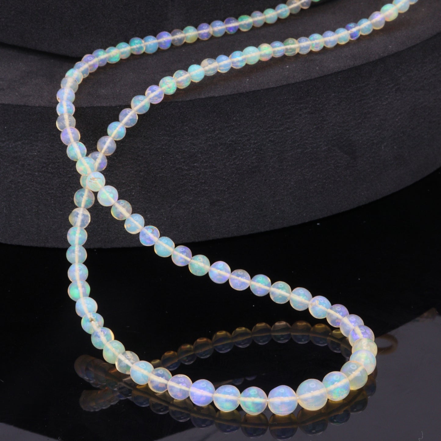 Warm White Ethiopian Opal 4mm - 5.5mm Smooth Rounds Bead Strand