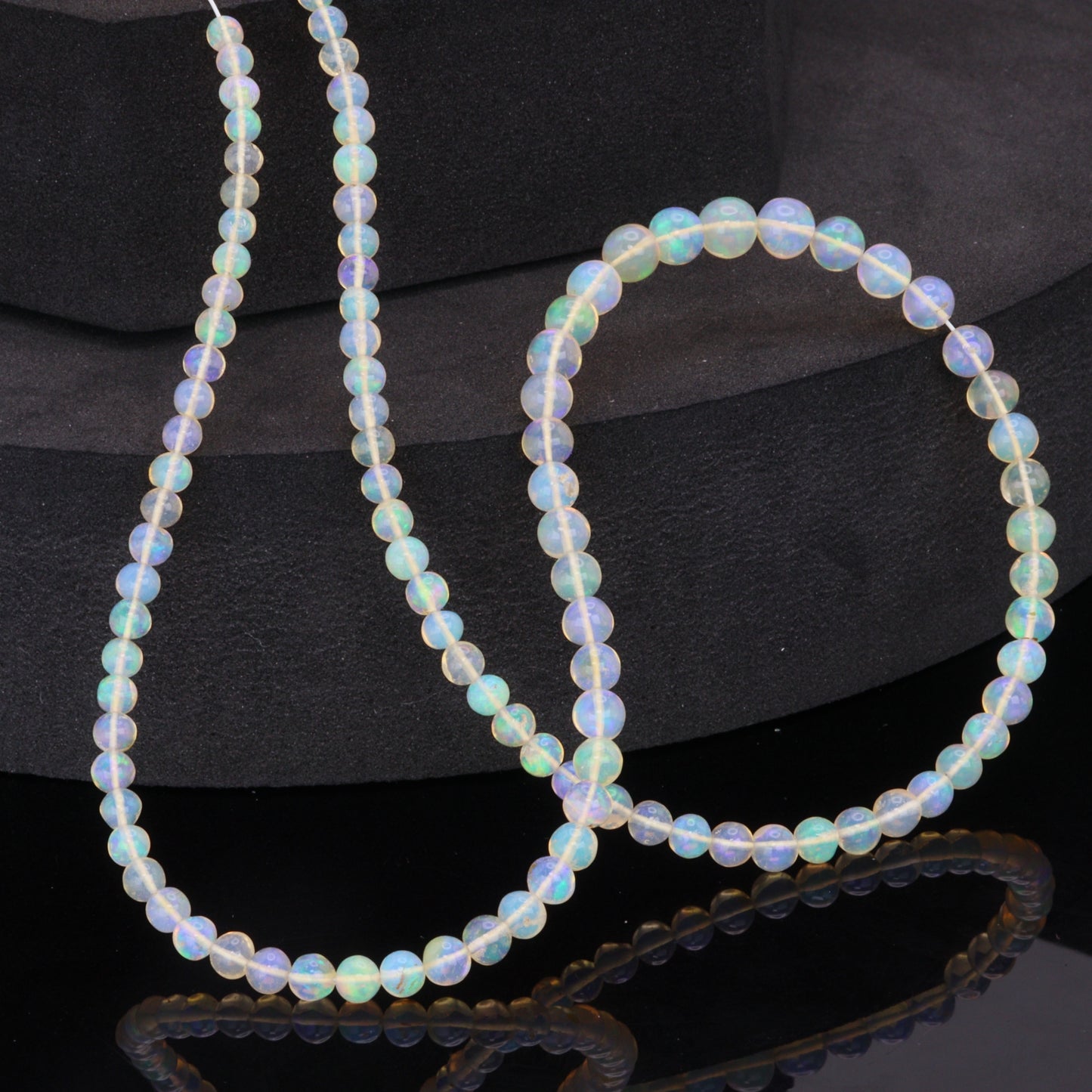 Warm White Ethiopian Opal 4mm - 5.5mm Smooth Rounds Bead Strand