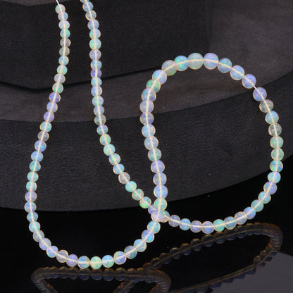 Warm White Ethiopian Opal 4mm - 5.5mm Smooth Rounds Bead Strand